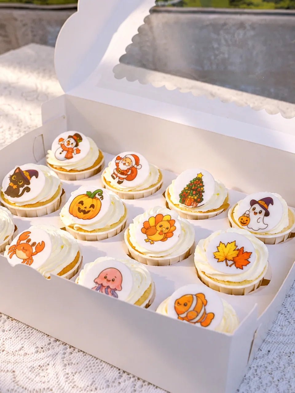 Cupcakes with colorful printed toppers featuring holiday and animal designs.