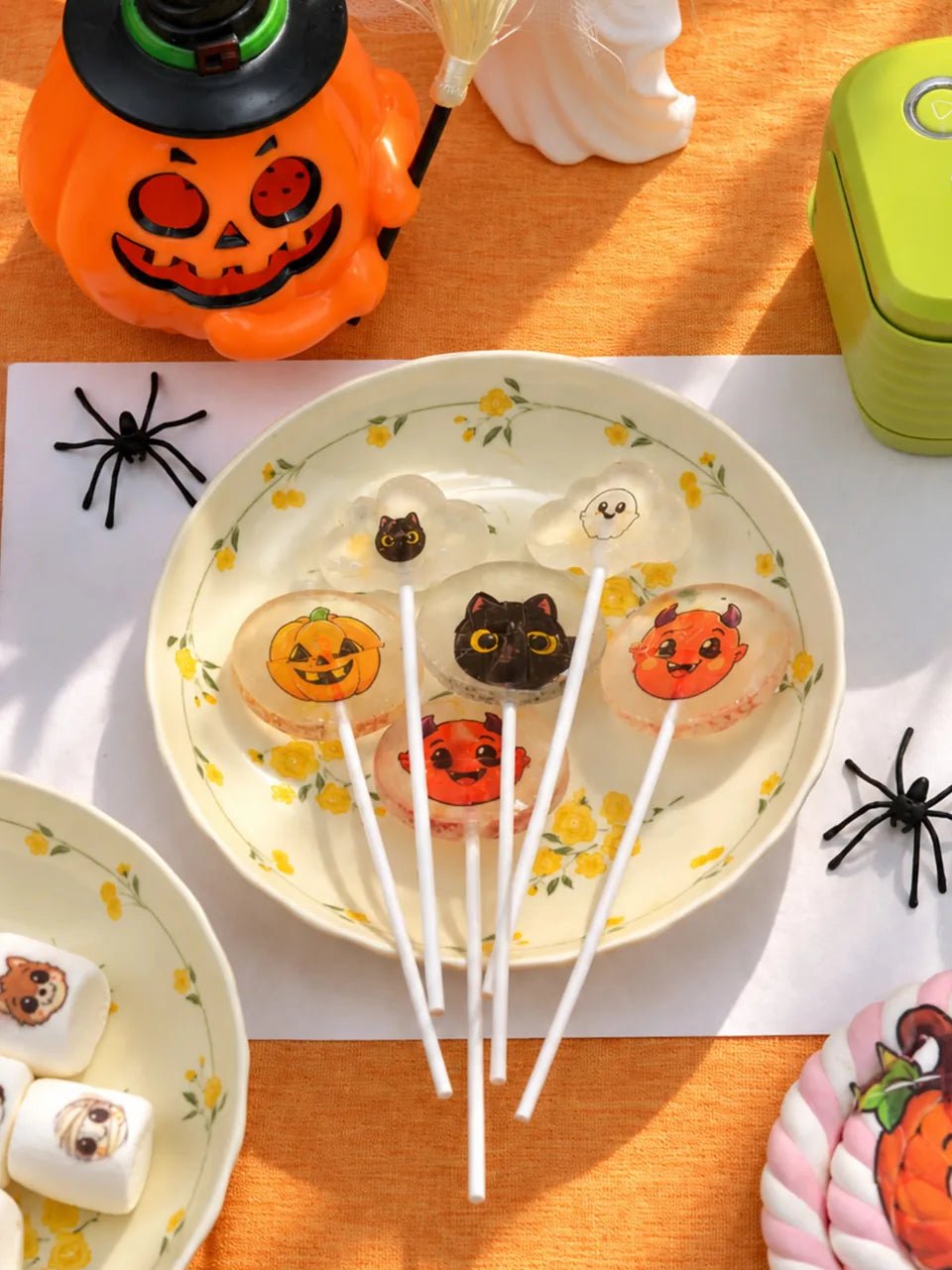 Pumpkin, black cat, ghost and devil designs on clear lollipops.